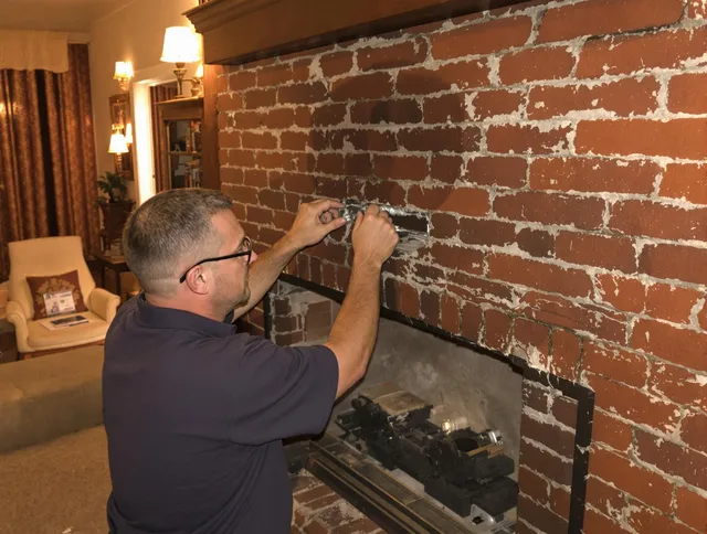 Tolland Chimney Sweep expert fixing a fireplace in Tolland, CT